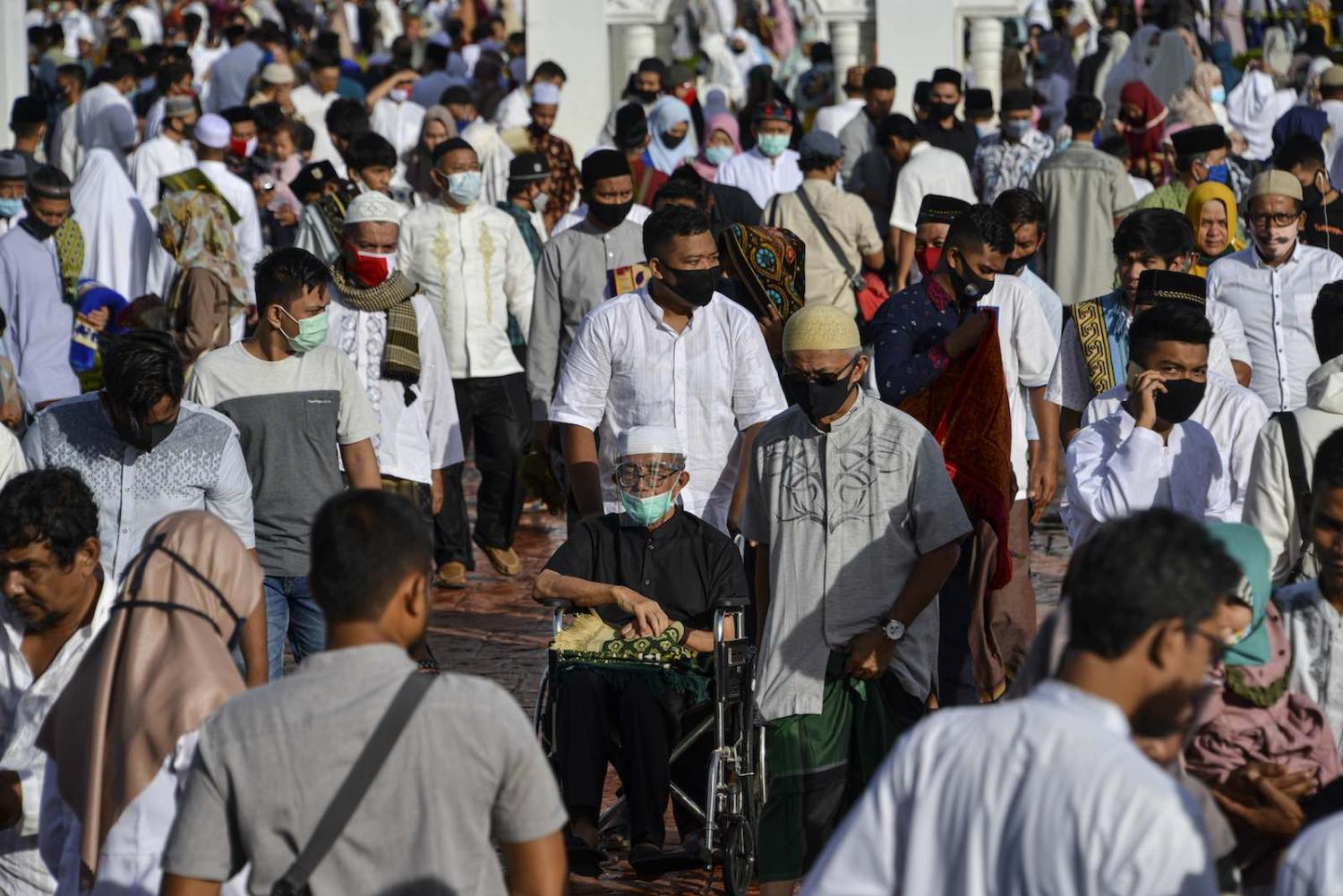 People gather after Eid al-Adha prayer at the Baiturrahman grand mosque in Banda Aceh, Indonesia, 31 July 2020 (Chaideer Mahyuddin/AFP)